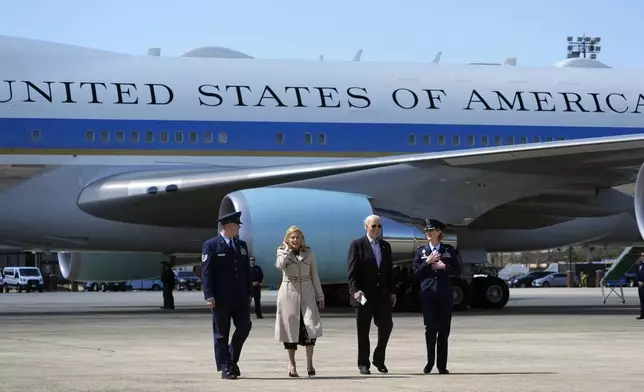 FILE - President Joe Biden, center right, and first lady Jill Biden, center left, walk off Air Force One, March 29, 2024, at Andrews Air Force Base, Md. The White House and the Democratic National Committee are splitting the cost of Biden’s travel while he runs for a second term. It’s part of a longstanding arrangement that prevents taxpayers from being stuck with the full bill for political trips. (AP Photo/Alex Brandon, File)