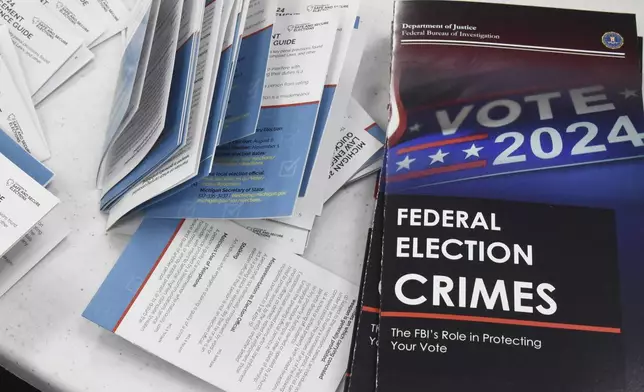 Educational materials provided by the Committee of Safe and Secure Elections are pictured at a conference with local election and law enforcement officials Wednesday, April 10, 2024, in Traverse City, Mich. A top concern for local election workers throughout the country this year is their own safety. The committee, formed after the 2020 presidential election, is traveling the country helping them prepare for what could lie ahead and making sure they are connected to local law enforcement. (AP Photo/John L. Russell)