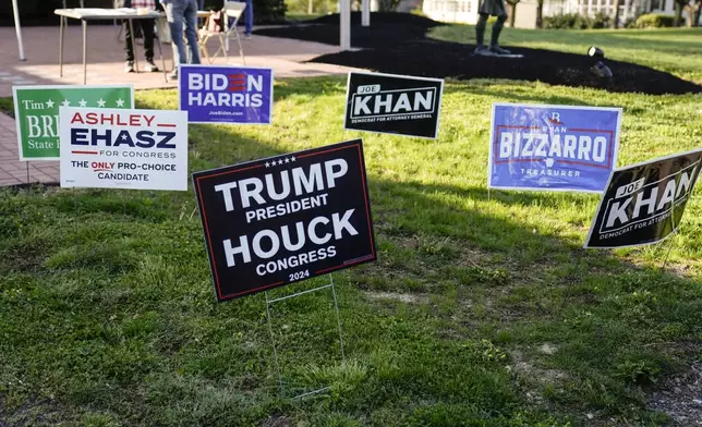 Campaign signs are posted outside of a polling site in Doylestown, Pa., Tuesday, April 23, 2024. (AP Photo/Matt Rourke)