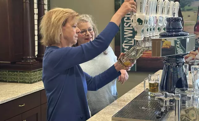 Wisconsin Democratic U.S. Sen. Tammy Baldwin talks to New Glarus Brewing Company co-owner Deb Carey during a campaign stop, Thursday, March 28, 2024, in New Glarus, Wis. The stop was part of her campaign launch tour in a race against Republican Eric Hovde the could determine who has majority control of the Senate. The Wisconsin Senate race between Democratic Sen. Tammy Baldwin and Republican Eric Hovde is setting up as one of the most competitive and expensive Senate races in the country. (AP Photo/Scott Bauer)