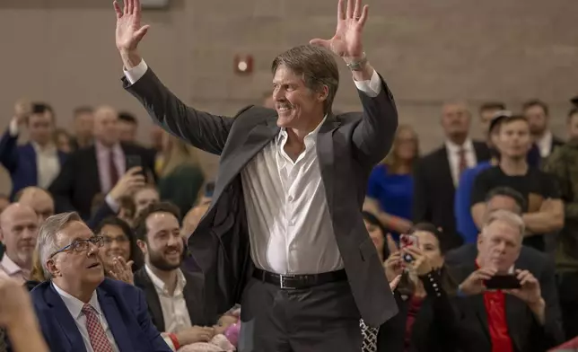 Madison, Wis businessman and Republican U.S. Senate candidate, Eric Hovde stands up after being acknowledged, Tuesday April 2, 2024, at a former President Donald Trump rally in Green Bay, Wis. The Wisconsin Senate race between Democratic Sen. Tammy Baldwin and Republican Eric Hovde is setting up as one of the most competitive and expensive Senate races in the country. (AP Photo/Mike Roemer)