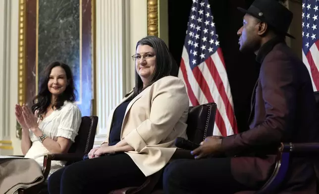 Shelby Rowe, center, Executive Director of the Suicide Prevention Research Center, flanked by Ashley Judd, left, and singer-songwriter Aloe Blacc, right, finishes speaking during an event on the White House complex in Washington, Tuesday, April 23, 2024, with notable suicide prevention advocates. The White House held the event on the day they released the 2024 National Strategy for Suicide Prevention to highlight efforts to tackle the mental health crisis and beat the overdose crisis. (AP Photo/Susan Walsh)