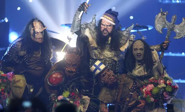 FILE - Finnish group Lordi celebrate after their victory in the Eurovision Song Contest at the Indoor Olympic stadium in Athens, Greece, May 21, 2006. The 68th Eurovision Song Contest is taking place in May in Malmö, Sweden. It will see acts from 37 countries vie for the continent’s pop crown. Founded in 1956, Eurovision is a feelgood extravaganza that strives to banish international strife and division. It’s known for songs that range from anthemic to extremely silly, often with elaborate costumes and spectacular staging. (AP Photo/Petros Giannakouris, File)