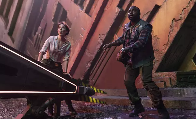 This image released by Warner Bros Pictures shows Rebecca Hall, left, and Brian Tyree Henry in a scene from "Godzilla X Kong: The New Empire." (Warner Bros. Pictures via AP)