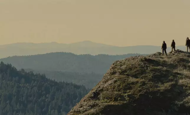 This image released by Bleeker Street shows Jesse Eisenberg, Riley Keough, and Nathan Zellner in a scene from the film "Sasquatch Sunset." (Bleeker Street via AP)