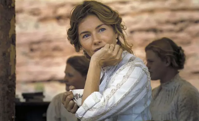 This image released by Warner Bros. Pictures shows Sienna Miller in a scene from "Horizon: An American Saga - Chapter 1." (Warner Bros. Pictures via AP)