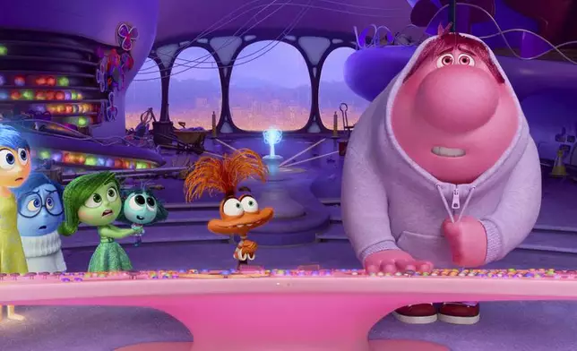This image released by Disney/Pixar shows, from left, Anger, voiced by Lewis Black, Fear, voiced by Tony Hale, Joy, voiced by Amy Poehler, Sadness, voiced by Phyllis Smith, Disgust, voiced by Liza Lapira, Envy, voiced by Ayo Edebiri, Anxiety, voiced by Maya Hawke and Embarrassment, voiced by Paul Walter Hauser, in a scene from "Inside Out 2." (Disney/Pixar via AP)