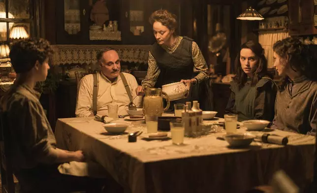 This image released by Disney shows Kim Bodnia as Henry Ederle, Jeanette Hain as Gertrud Ederle, Daisy Ridley as Trudy Ederle in a scene from "Young Woman and the Sea." (Vladisav Lepoev/Disney via AP)