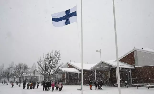The flag of Finland flies at half-mast at the Viertola school in Vantaa, Finland, on Wednesday, April 3, 2024. A 12-year-old student opened fire at a secondary school in southern Finland on Tuesday morning, killing one and seriously wounded two other students, police said. The suspect was later arrested. (Jussi Nukari/Lehtikuva via AP)