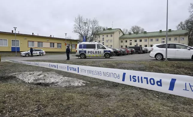 Police officers stand guard outside Viertola comprehensive school, in Vantaa, Finland, Tuesday, April 2, 2024. Police in Finland say a 12-year-old student has opened fire at a secondary school in southern Finland and wounded three other students. The suspect was later arrested. Heavily armed police on Tuesday cordoned off the lower secondary school, with some 800 students, in the city of Vantaa, just outside the capital, Helsinki, after receiving a call about a shooting incident at 09:08 a.m. Police said both the suspect and the wounded were 12 years old. (Markku Ulander/Lehtikuva via AP)