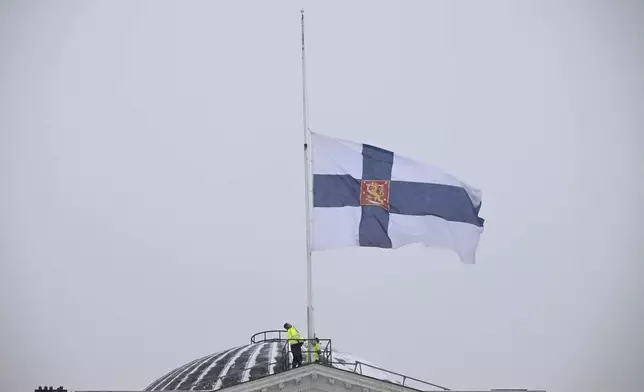National flag of Finland flies at half-mast outside Government Palace by Senate Square in Helsinki, Finland Wednesday, April 3, 2024. A 12-year-old student opened fire at a secondary school in southern Finland on Tuesday morning, killing one and seriously wounded two other students, police said. The suspect was later arrested. (Antti Aimo-Koivisto/Lehtikuva via AP)
