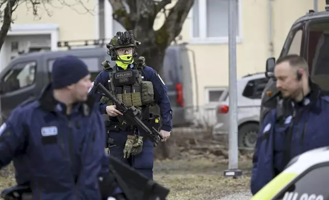Police officers patrol outside Viertola comprehensive school, in Vantaa, Finland, Tuesday, April 2, 2024.Police in Finland say a 12-year-old student has opened fire at a secondary school in southern Finland and wounded three other students. The suspect was later arrested. Heavily armed police on Tuesday cordoned off the lower secondary school, with some 800 students, in the city of Vantaa, just outside the capital, Helsinki, after receiving a call about a shooting incident at 09:08 a.m. Police said both the suspect and the wounded were 12 years old. (Markku Ulander/Lehtikuva via AP)