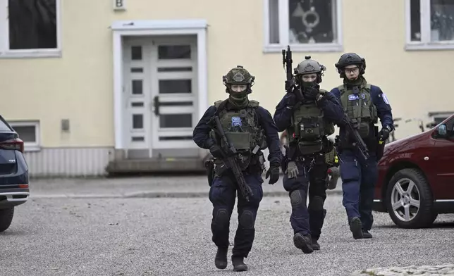 Police officers at the scene of Viertola comprehensive school, in Vantaa, Finland, Tuesday, April 2, 2024. Finnish police say a number of people were wounded in a shooting at a school outside Helsinki and a suspect was detained. (Markku Ulander/Lehtikuva via AP)