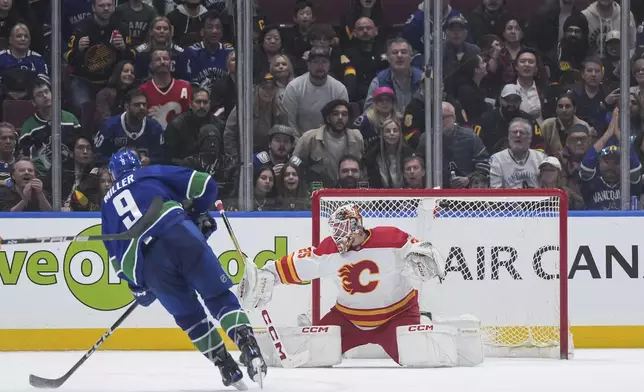 Vancouver Canucks' J.T. Miller (9) shoots against Calgary Flames goalie Jacob Markstromduring the third period of an NHL hockey game Tuesday, April 16, 2024, in Vancouver, British Columbia. (Darryl Dyck/The Canadian Press via AP)