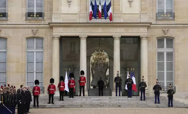 British soldiers and Republican Guards stand guard at the Elysee Palace, Monday, April 8, 2024 in Paris. Sixteen soldiers from No 7 Company Coldstream Guards and 32 members of the Gendarmerie Garde Republicaine mount guard at the Elysee palace as British troops join French guards in a special ceremony at the Elysee Palace to celebrate 120 years of "entente cordiale" between the longtime rival powers. (AP Photo/Thibault Camus, Pool)
