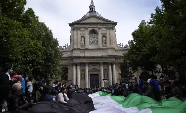 Students demonstrate outside La Sorbonne university with a huge Palestinian flag, Monday, April 29, 2024 in Paris. About 100 Pro-Palestinian students demonstrate near the Sorbonne university in Paris. The demonstration came on the heels of protests last week at another Paris-region school, Sciences Po. (AP Photo/Christophe Ena)