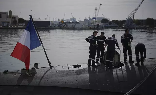 Sailors prepare a French Rubis-class submarine at the Toulon naval base in southern France, Monday, April 15, 2024. The nuclear powered submarine will be guarding France's Charles de Gaulle aircraft carrier during training exercises dubbed Neptune Strike in the Mediterranean with the 32-nation NATO military alliance. (AP Photo/Daniel Cole)