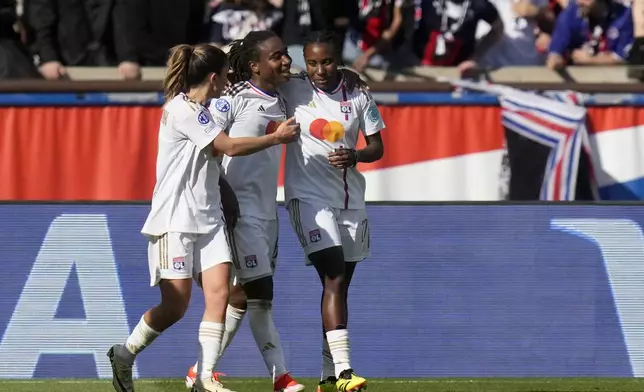 Lyon's Melchie Dumornay, center, celebrates after scoring her side's second goal during the women's Champions League semifinal, second leg, soccer match between Paris Saint-Germain and Olympique Lyonnais at Parc des Princes, in Paris, Sunday, April 28, 2024. (AP Photo/Thibault Camus)