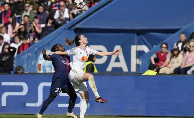 Lyon's Damaris Egurrola vies for the ball with PSG's Tabitha Chawinga, left, during the women's Champions League semifinal, second leg, soccer match between Paris Saint-Germain and Olympique Lyonnais at Parc des Princes, in Paris, Sunday, April 28, 2024. (AP Photo/Thibault Camus)