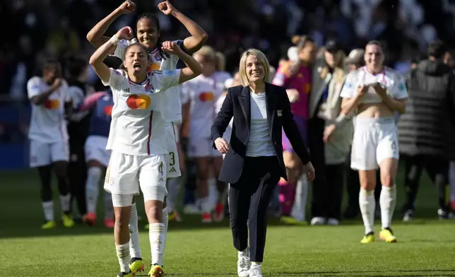 Lyon's Selma Bacha, Wendie Renard and coach Sonia Bompastor, from left, celebrate at the end of the women's Champions League semifinal, second leg, soccer match between Paris Saint-Germain and Olympique Lyonnais at Parc des Princes, in Paris, Sunday, April 28, 2024. Lyon won 2-1 to advance to the final. (AP Photo/Thibault Camus)