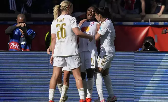 Lyon's Melchie Dumornay, center, celebrates after scoring her side's second goal during the women's Champions League semifinal, second leg, soccer match between Paris Saint-Germain and Olympique Lyonnais at Parc des Princes, in Paris, Sunday, April 28, 2024. (AP Photo/Thibault Camus)