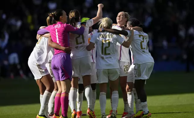 Lyon's Lindsey Horan, 2nd right, and her teammates celebrate at the end of the women's Champions League semifinal, second leg, soccer match between Paris Saint-Germain and Olympique Lyonnais at Parc des Princes, in Paris, Sunday, April 28, 2024. Lyon won 2-1 to advance to the final. (AP Photo/Thibault Camus)