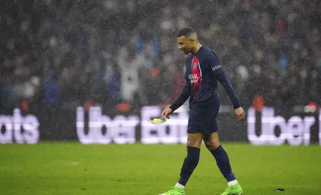 PSG's Kylian Mbappe leaves the pitch during the French League One soccer match between Marseille and Paris at the Velodrome stadium in Marseille, south of France, Sunday, March 31, 2024. (AP Photo/Daniel Cole)