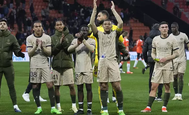 PSG players with Kylian Mbappe, arms in the air, celebrate after the French League One soccer match between Lorient and Paris Saint-Germain at the Moustoir stadium in Lorient, Brittany, western France, Wednesday, April 24, 2024. (AP Photo/Michel Euler)