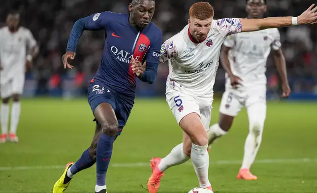 Clermont's Maximiliano Caufriez, right, and PSG's Randal Kolo Muani compete for the ball during the French League One soccer match between Paris Saint-Germain and Clermont at the Parc des Princes stadium in Paris, Saturday, April 6, 2024. (AP Photo/Lewis Joly)