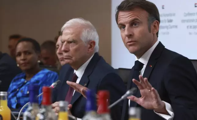 French President Emmanuel Macron, right, speaks during a session at the international conference on Sudan, Monday, April 15, 2024 in Paris. Top diplomats and aid groups met in the French capital to drum up humanitarian support for Sudan after a yearlong war has devastated the northeastern African country and pushed its people to the brink of famine. (AP Photo/Aurelien Morissard; Pool)