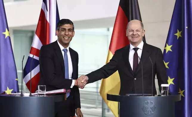 German Chancellor Olaf Scholz, right, and Britain's Prime Minister Rishi Sunak shake hands during a joint press conference at the Chancellery in Berlin, Wednesday April 24, 2024. (Henry Nicholls/Pool via AP)