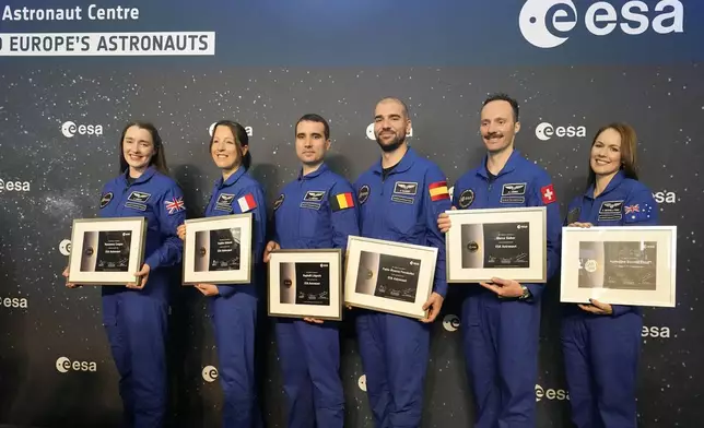 From left, Rosemary Cooga of Britain, Sophie Adenot of France, Raphael Liegeois of Belgium, Pablo Alvarez Fernandez of Spain, Marco Sieber of Switzerland, and Katherine Bennell-Pegg of Australia, from left, hold there certificates at the graduation ceremony of astronaut candidates of the Class of 2022 at the European Astronaut Centre in Cologne, Germany, Monday, April 22, 2024. The new ESA astronauts took up duty at the European Astronaut Centre one year ago to be trained to the highest level of standards as specified by the International Space Station partners. Also concluding a year of astronaut basic training is Australian astronaut candidate Katherine Bennell-Pegg, who has trained alongside ESA's candidates. (AP Photo/Martin Meissner)