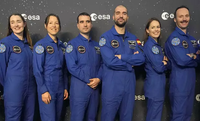 From left, Rosemary Cooga of Britain, Sophie Adenot of France, Raphael Liegeois of Belgium, Pablo Alvarez Fernandez of Spain, Katherine Bennell-Pegg of Australia and Marco Sieber of Switzerland, pose for a family photo at the graduation ceremony of astronaut candidates of the Class of 2022 at the European Astronaut Centre in Cologne, Germany, Monday, April 22, 2024. The new ESA astronauts took up duty at the European Astronaut Centre one year ago to be trained to the highest level of standards as specified by the International Space Station partners. Also concluding a year of astronaut basic training is Australian astronaut candidate Katherine Bennell-Pegg, who has trained alongside ESA's candidates. (AP Photo/Martin Meissner)
