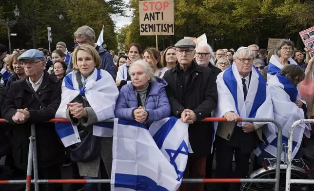 FILE - People listen to speeches during a demonstration against antisemitism and to show solidarity with Israel in Berlin, Germany, on Oct. 22, 2023. More than 250 Holocaust survivors have joined an international initiative to share their stories of loss and survival with students around the world during a time of rising antisemitism following the Oct. 7 Hamas attack on Israel that triggered the war in the Gaza Strip. The Survivor Speakers Bureau was launched Thursday by the New York-based Conference on Jewish Material Claims Against Germany, also referred to as the Claims Conference. (AP Photo/Markus Schreiber, File)