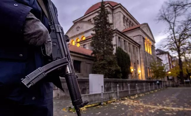 FILE - A German police officer stands guard in front of the synagogue in Frankfurt, Germany, on Nov. 8, 2023. Antisemitism is spiking across Europe after Hamas' Oct. 7 massacre and Israel's bombardment of Gaza, worrying Jews from London to Geneva and Berlin. (AP Photo/Michael Probst, File)