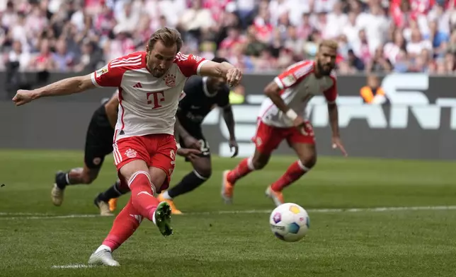 Bayern's Harry Kane scores his side's second goal from penalty during the German Bundesliga soccer match between Bayern Munich and Eintracht Frankfurt, at the Allianz Arena in Munich, Germany, Saturday, April 27, 2024. (AP Photo/Matthias Schrader)
