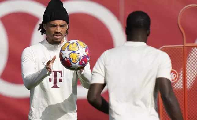 Bayern's Leroy Sane, rear, catches a ball next to Bayern's Dayot Upamecano during a training session in Munich, Germany, Monday, April 29, 2024, ahead of the Champions League semi final first leg soccer match between FC Bayern Munich and Real Madrid. (AP Photo/Matthias Schrader)