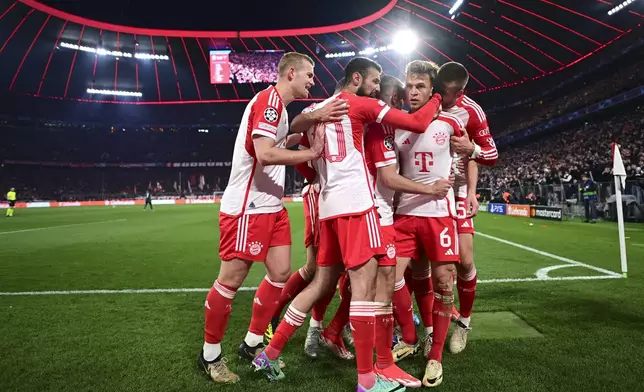 Bayern's Joshua Kimmich, centre right, celebrates with teammates after scoring his side's opening goal during the Champions League quarter final second leg soccer match between Bayern Munich and Arsenal at the Allianz Arena in Munich, Germany, Wednesday, April 17, 2024. (AP Photo/Christian Bruna)