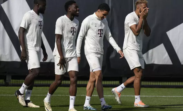 From left, Bayern's Dayot Upamecano, Alphonso Davies, Jamal Musiala, and Eric Maxim Choupo-Moting arrive for a training session in Munich, Germany, Monday, April 29, 2024, ahead of the Champions League semi final first leg soccer match between FC Bayern Munich and Real Madrid. (AP Photo/Matthias Schrader)