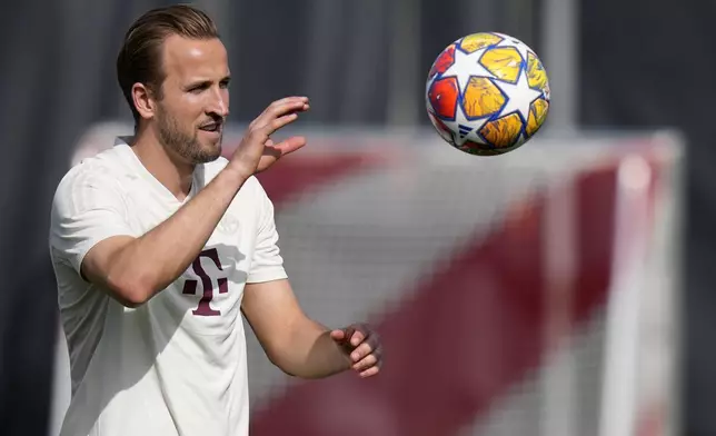 Bayern's Harry Kane catches a ball during a training session in Munich, Germany, Monday, April 29, 2024, ahead of the Champions League semi final first leg soccer match between FC Bayern Munich and Real Madrid. (AP Photo/Matthias Schrader)