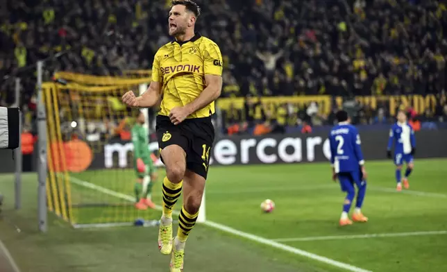 Dortmund's Niclas Fuellkrug celebrates after scoring his side's third goal during the Champions League quarterfinal second-leg soccer match between Borussia Dortmund and Atletico Madrid at the Signal-Iduna Park in Dortmund, Germany, Tuesday, April 16, 2024. (Bernd Thissen/dpa via AP)