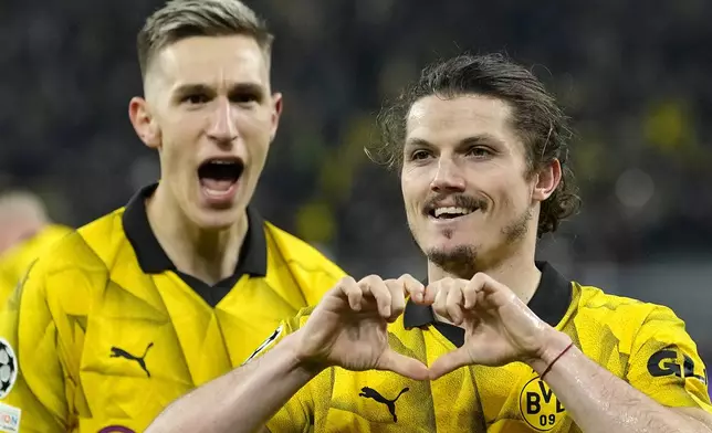 Dortmund's Marcel Sabitzer, right, celebrates his side's 4th goal during the Champions League quarterfinal second leg soccer match between Borussia Dortmund and Atletico Madrid at the Signal-Iduna Park in Dortmund, Germany, Tuesday, April 16, 2024(AP Photo/Martin Meissner)