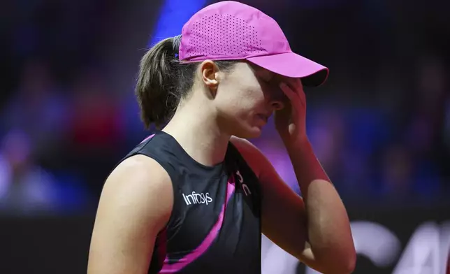 Poland's Iga Swiatek reacts during her semifinal match of the WTA Tour against Kazakhstan's Elena Rybakina, in Stuttgart, Germany, Saturday April 20, 2024. (Marijan Murat/dpa via AP)