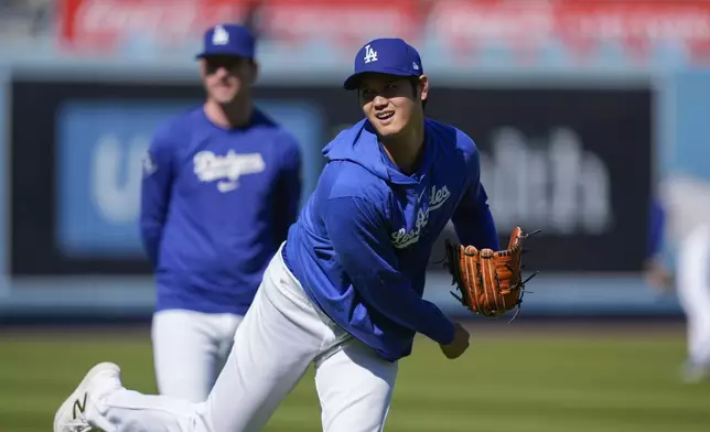 Los Angeles Dodgers designated hitter Shohei Ohtani warms up for the team's baseball game against the San Francisco Giants, Tuesday, April 2, 2024, in Los Angeles. (AP Photo/Ryan Sun)