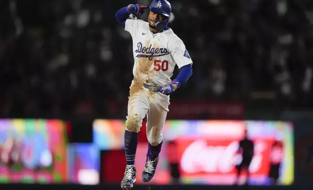 Los Angeles Dodgers' Mookie Betts celebrates a home run against the San Francisco Giants during the third inning of a baseball game Tuesday, April 2, 2024, in Los Angeles. (AP Photo/Ryan Sun)