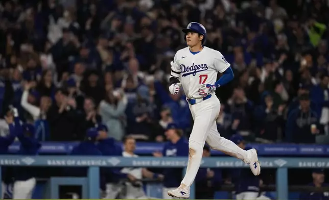 Los Angeles Dodgers designated hitter Shohei Ohtani runs the bases after hitting a home run during the seventh inning of a baseball game against the San Francisco Giants in Los Angeles, Wednesday, April 3, 2024. (AP Photo/Ashley Landis)