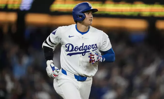 Los Angeles Dodgers designated hitter Shohei Ohtani runs the bases after hitting a home run during the seventh inning of a baseball game against the San Francisco Giants in Los Angeles, Wednesday, April 3, 2024. (AP Photo/Ashley Landis)