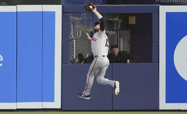 San Francisco Giants right fielder Austin Slater (13) catches a hit by Miami Marlins' Jazz Chisholm Jr., during the first inning of a baseball game, Wednesday, April 17, 2024, in Miami. (AP Photo/Marta Lavandier)