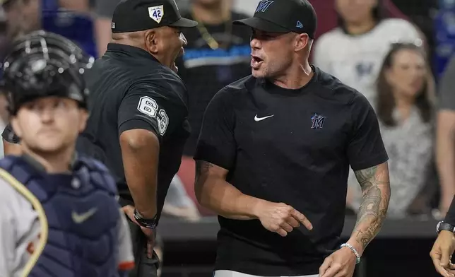 Miami Marlins manager Skip Schumaker argues a call by umpire Laz Diaz (63) during the eighth inning of a baseball game, Monday, April 15, 2024, in Miami. Schumaker was ejected from the game. (AP Photo/Marta Lavandier)