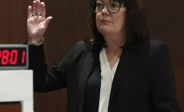 Dr. Deborah Collins, PhD, a specialist in psychology, is sworn in during a motion hearing for Morgan Geyser in Waukesha County Circuit Court on Wednesday, April 10, 2024, in Waukesha, Wis. Two psychologists testified Wednesday that Geyser, who at age 12 stabbed a sixth-grade classmate nearly to death to please the online horror character Slender Man, should not be released yet from a psychiatric hospital. (Scott Ash/Milwaukee Journal-Sentinel via AP)
